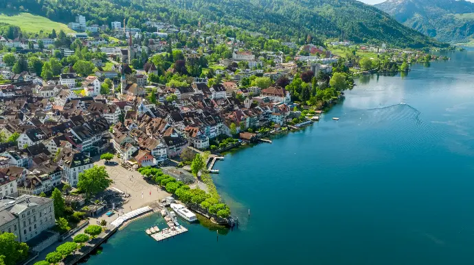 aerial view of city buildings near body of water during daytime